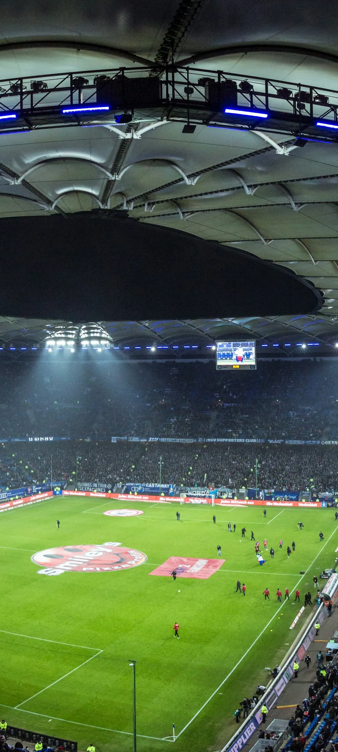 A floodlit stadium on matchday